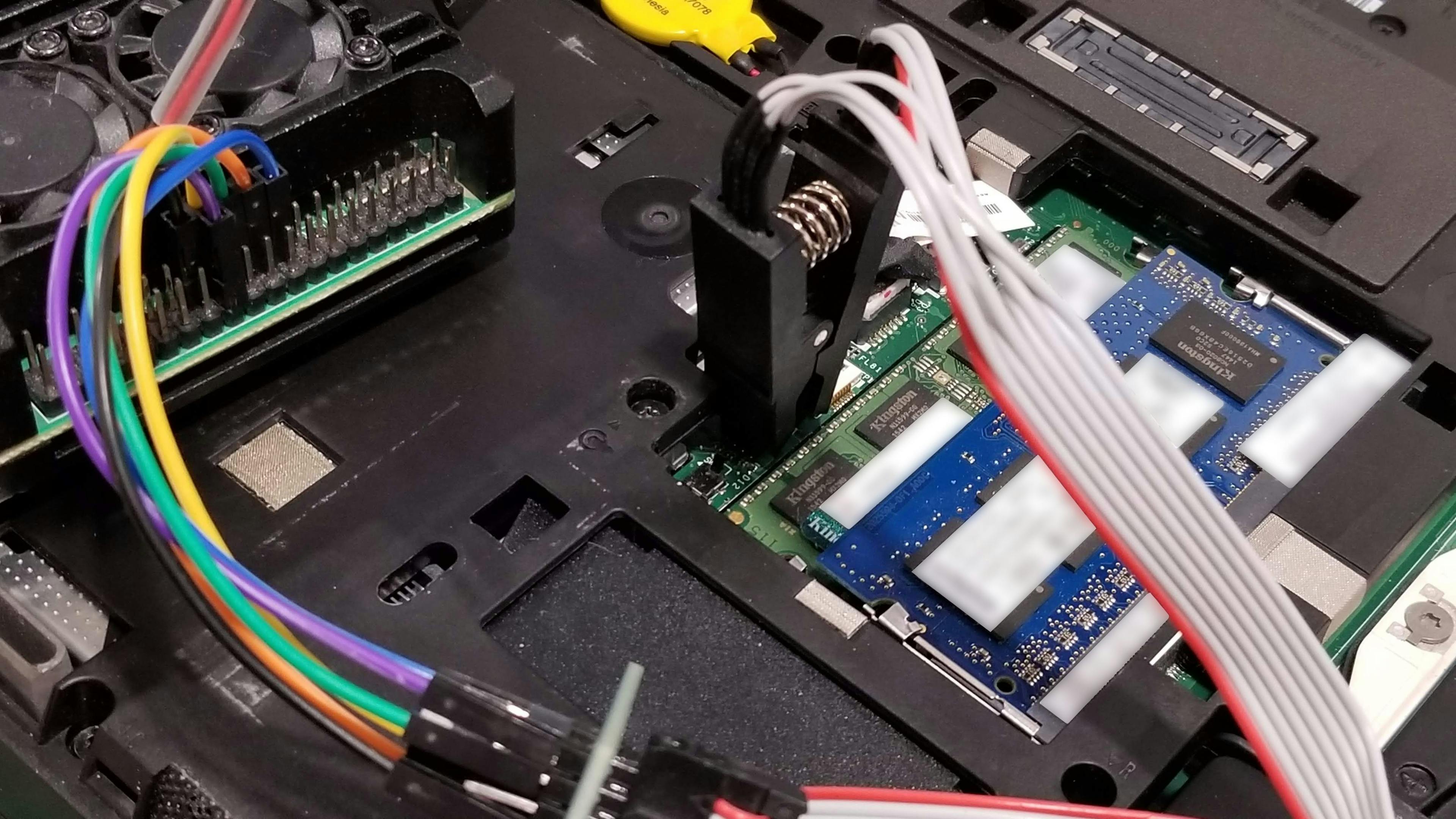 The BIOS chip being connected to the Raspberry Pi using wires.