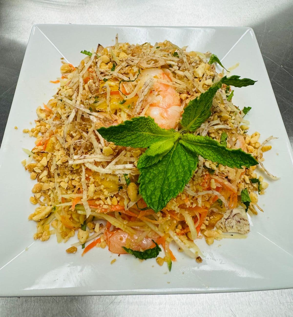 Pad Thai topped with mint and crushed peanuts.